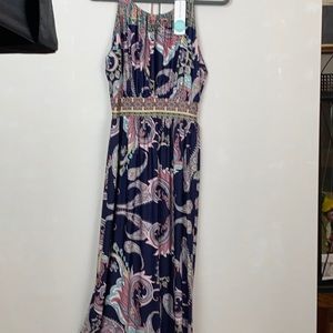 Long dress made by Gilli and sold by stitch fix. Primary color is navy